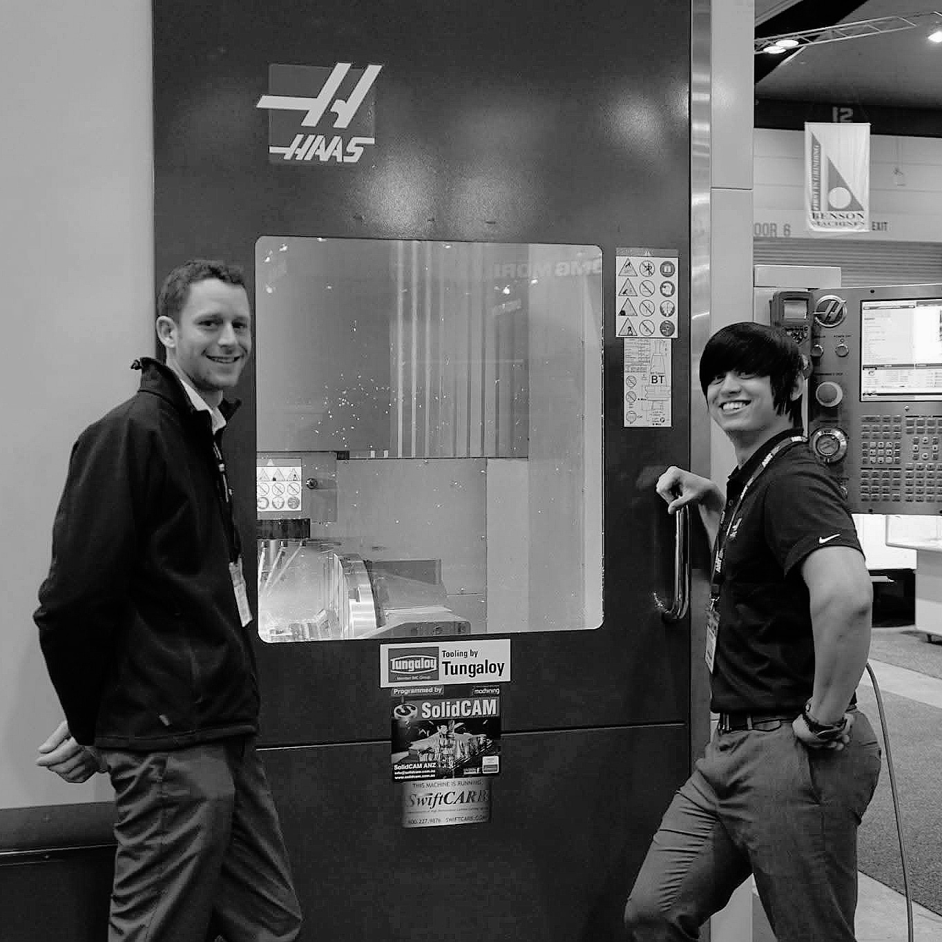 Travis and Darcy, co-founders, beside a HAAS CNC machine